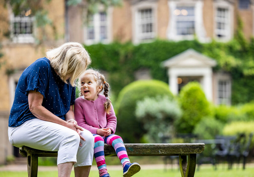 girl sitting with her teacher