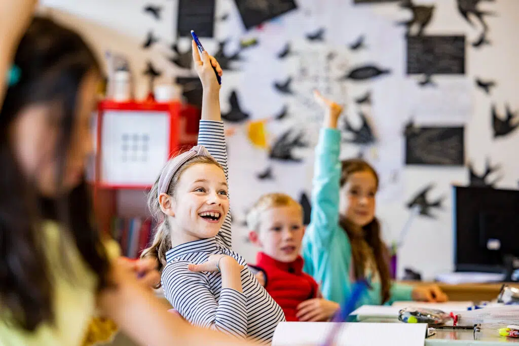 children with their hands up