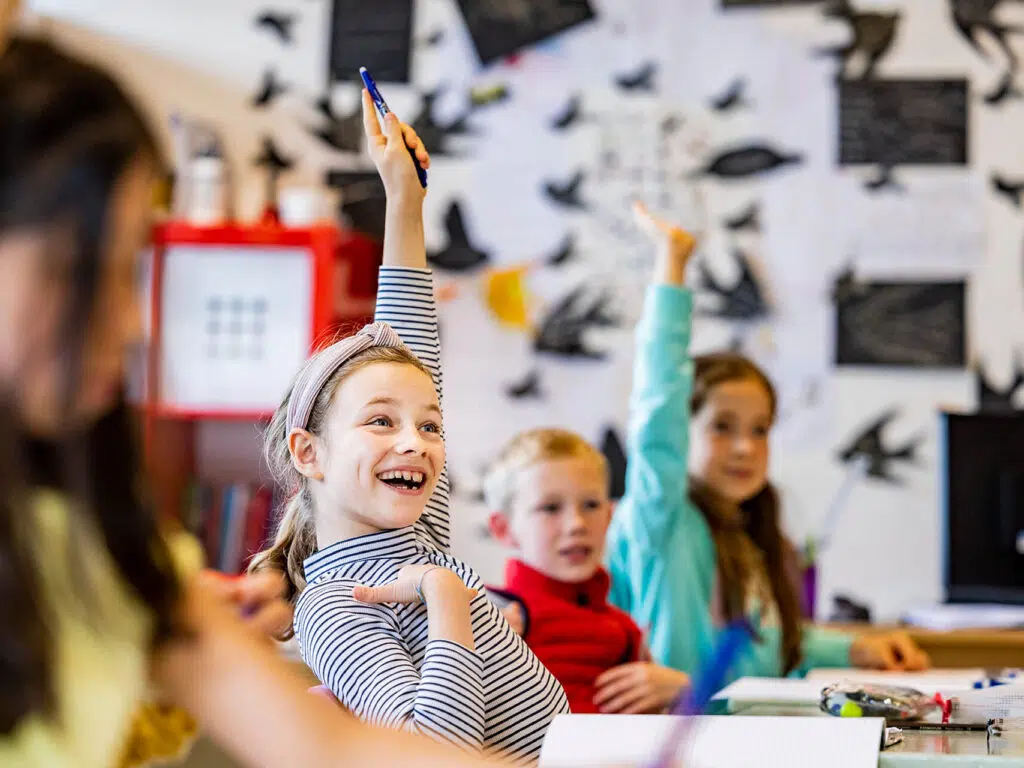 children with their hands up