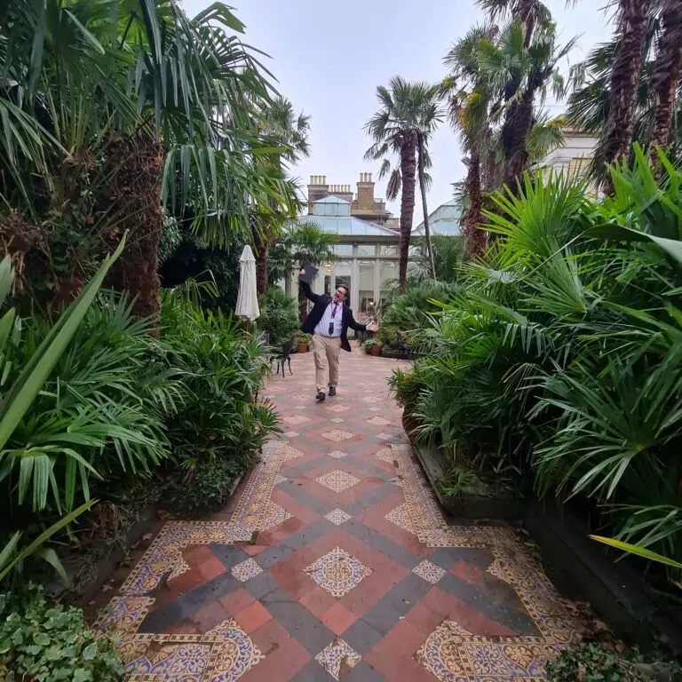 man walking down the garden area