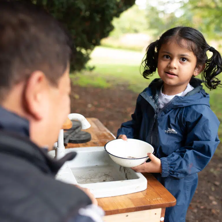 student washing her bowl