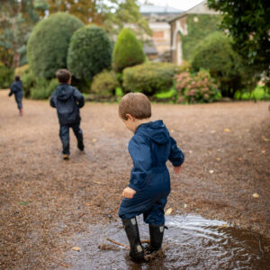 student splashing in a puddle