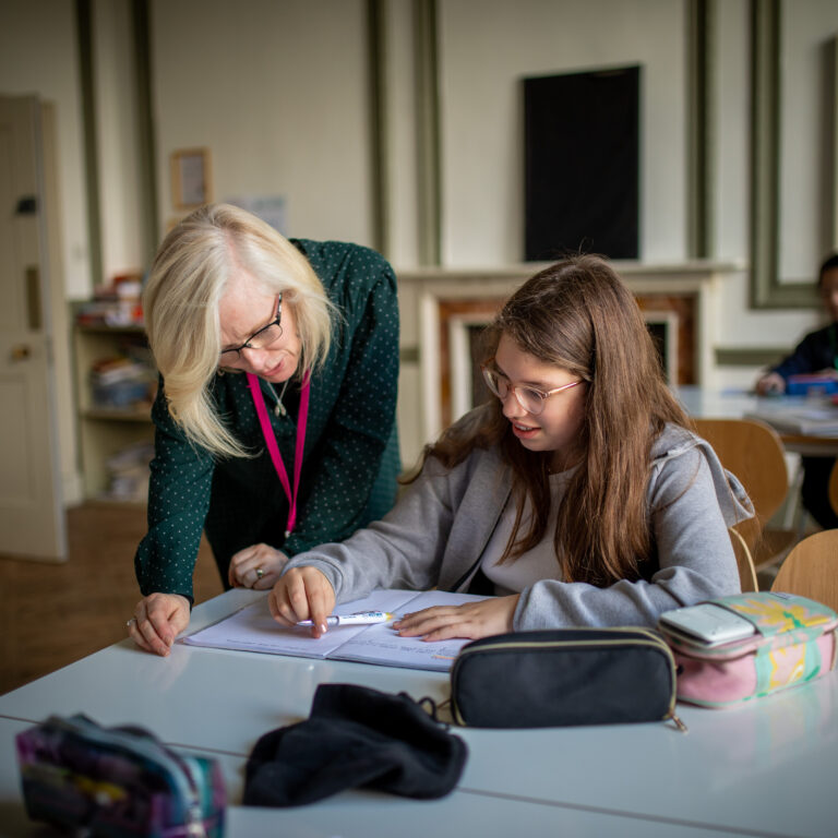 student getting help from her teacher
